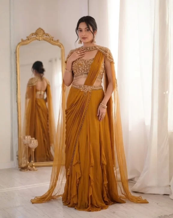 Elegant Fancy Lehenga Choli crafted with Rangoli fabric, featuring a beautifully embroidered Banglori blouse, fancy latkan lace dupatta, and a graceful 3.5-meter flair. Perfect for weddings, festive occasions and parties. Lehenga Fabric: Rangoli FabricLehenga Flair: 3.5 MeterBlouse Fabric: BangloriBlouse: Fully StitchedBlouse Work: Embroidery & Sequin WorkSleeves: Long SleevesDupatta: Heavy Rangoli FancyDupatta Work: Latkan LaceWeight: 1 KgColor: Mustard / Yellow Package Includes 1 Lehenga 1 Fully Stitched Blouse 1 Dupatta